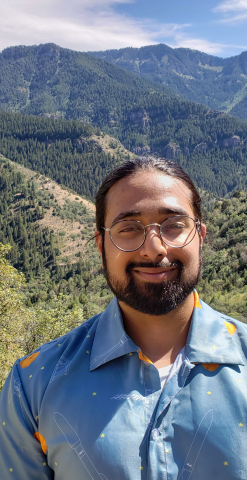 Nir Patel headshot with Boulder foothills background
