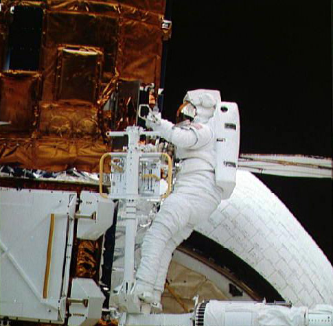 The satellite is loaded into the Space Shuttle's cargo bay, where it was successfully repaired by the shuttle astronauts