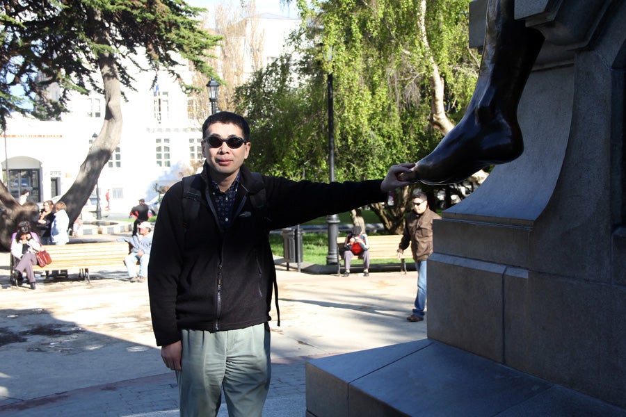 Touching Aónikenk Indian's foot in Punta Arenas.