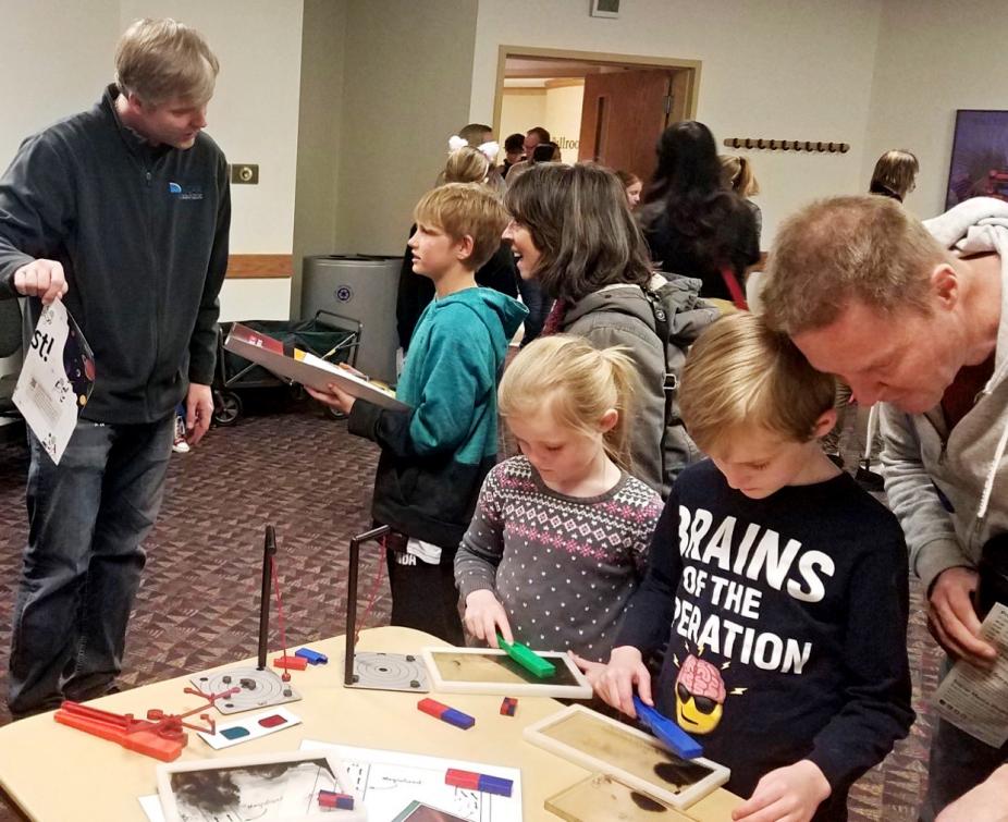 Ricky Egeland (left) mentoring children at 2020 Little Shop of Physics with hands-on activities