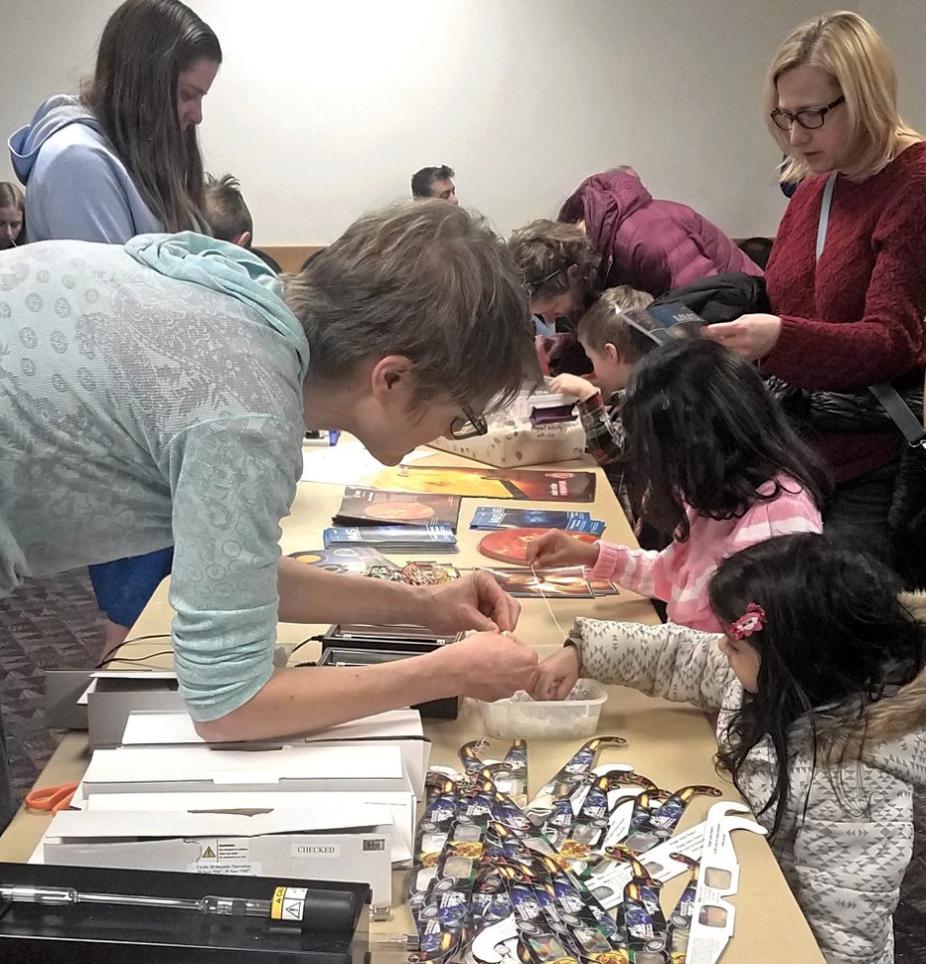 Astrid Maute (left) instructing children at 2020 Little Shop of Physics with hands-on activities