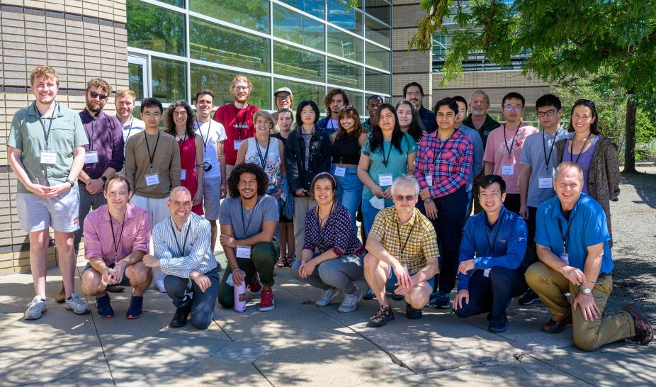 Smiling group of Spectropolarimetry school students and lecturers taken on the outdoor patio at Center Green 1 building.