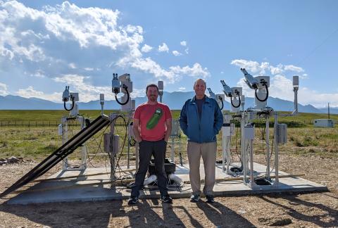 Damon Burke and Steve Tomczyk standing in front of optical equipment at Marshall Fields