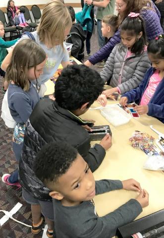 Photograph of children at 2020 Little Shop of Physics with hands-on activities