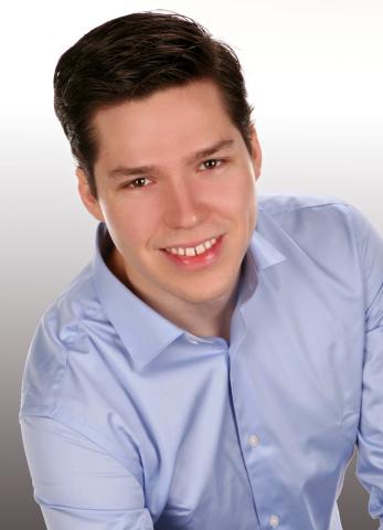 Robert Jarolim head portrait with blue button-down shirt