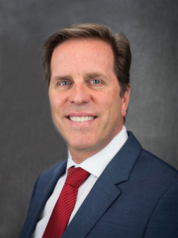 Tom Berger in suit and red tie