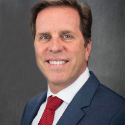 Tom Berger in suit and red tie